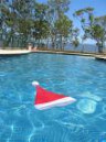 Santa's cap floating on a swimming pool